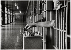 history-inpictures:  Two inmates, one black and one white, playing chess from between the bars of their prison cells, 1972