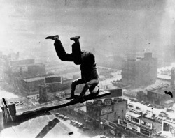Man balancing on Chicago skyscraper, 1932.