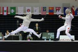 modernfencing:  [ID: a sabre fencer doing a leaping lunge at her retreating opponent.]Kim Ji-yeon (left) against Shen Chen at the 2015 Asian Fencing Championships! 