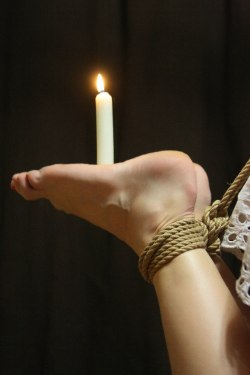littlesylver:  The feet are a place Sir has yet to play with wax. As ticklish as mine are, I am afraid I would set the house on fire if he actually asked me to balance a candle there. He has asked me to keep a candle balanced on my tummy while he did
