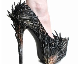 awesomeshityoucanbuy:  Iron Throne High HeelsThe King might sit on the Iron Throne, but the Queen can look even more fabulous by wearing the Iron Throne shoes! These heels come cleverly decked out with dozens of tiny plastic food pick swords spray painted