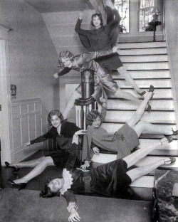 Girls goofing off on stairs, location unknown, ca. 1920s.