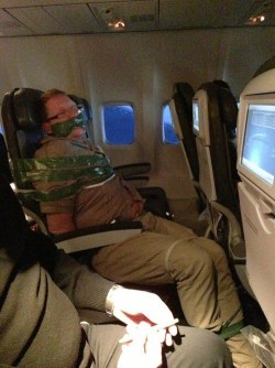thedailywhat:  Awkward Moment of the Day: Drunk Passenger Gets Duct Taped  Business developer Andy Elwood snapped this photo of a fellow passenger who had to be restrained during a flight from Iceland to New York City yesterday. Elwood noted that after
