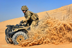 militaryarmament:  A soldier with the Unmanned Aerial System Battery manoevres a Quad Bike over the harsh desert terrain of Afghanistan. October 17, 2012.