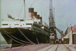 twostriptechnicolor: The RMS Aquitania heads to the ship breakers, 1950. (I usually keep my gifs pre-1950, but an Edwardian era four-stacker in color is really something!) 