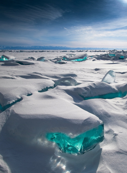  In March, due to a natural phenomenon, temperature, wind and sun cause the ice crust to crack and form beautiful turquoise blocks or ice hummocks on the surface of Lake Baikal in Siberia. Photographer: X 