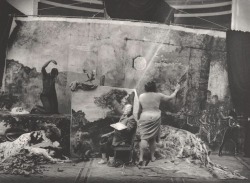 zzzze:Joel-Peter Witkin Studio of the Painter (Paris, 1990) [mannequin-like seated figure with palette by painting, female subjects reclining at left; fleshy female model with arm raised, back to camera; masked child figure and motion diagram at right]