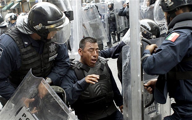 thesmithian:   Thousands of riot police retook Mexico City’s…Zócalo plaza…from