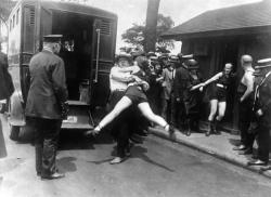 historicaltimes:  Woman being arrested for wearing one piece bathing suit &amp; showing a little leg. 1922 Chicago via reddit 