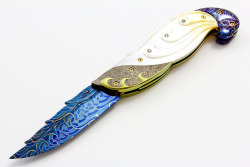whiskey-wolf:  Ū,500.00 Titanium and Gold Lip Pearl Linerlock This knife is from Suchat’s New Diamond Edition. This liner locking folder features a carved Robert Calcinore Mosaic Damascus blade. The handle has carved titanium bolsters, carved gold