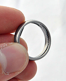 stfueverything:  survivetheinfection:  A titanium escape ring with a handcuff shim and a saw blade hidden inside, the shim can open single lock handcuffs and the saw blade can cut through zipcuffs, duct tape, and other types of restraints. buy one here