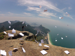 fartgallery:   tha guy on the cliff he just finished highschool and what he did was he threw all his school papers and books over the cliff screaming “take that” personally i think that its really cool because in a way its like hes free. He went through