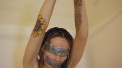 www.seductivestudios.com Daphne is tied arms overhead with duct tape covering her eyes, mouth, belly button, nipples and pussy. She struggles as the water is turned on and she is soaked, left to writhe naked and wet arms overhead&hellip; Available at