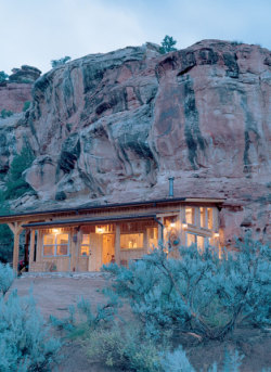 sleepingonparktables:  One of several places I stayed in Colorado. Built into the canyon cliff, one entire side of the house is rock; the shower and reading corner are natural recesses. Wood-burning stove, heated tile floors, and 2nd story loft for guest