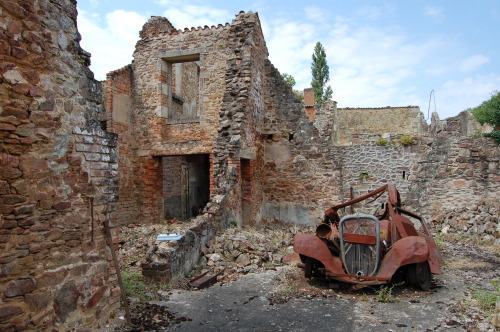 sixpenceee:  Oradour-Sur-Glane: This town was abandoned because the Nazis rounded all the citizens up and killed them. France left the entire town untouched as a memorial. The people were buried, but the items; cars, bikes, baby carriages, still remain.