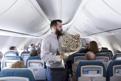 willcub:  gestopft:  NSO horns play “name that tune” with the rest of the orchestra on flight to Regensburg #NSOTour   Sexy French Horn-playing cub!  