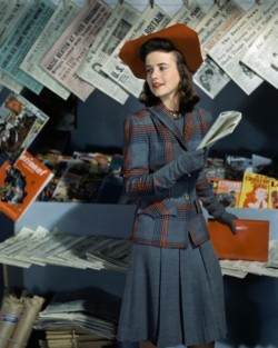 nineteen40s:  Dorothy Shapard, student at Vassar, in a career classic blue grey wool dress with a plaid jacket in blue, grey, red and black and a red hat, September 1941. 