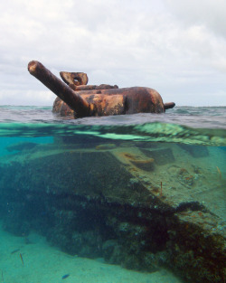 abandonedporn:  This US M4 Sherman Tank was stranded on the reef during the invasion of the island of Saipan during WWII. Its turret is still frozen in time, taking aim at a Japanese gun emplacement on the beach. 