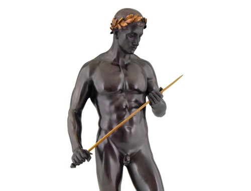 ganymedesrocks:Fritz Heinemann (1864 - 1932), was a German Sculptor.  The present bronze cast of a male nude warrior is said to be that of a study of a young Caesar.    The original cast is dated 1911, the sword and laurel wreath are gilded.    