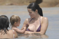 toplessbeachcelebs:  Courtney Cox (Actress) bikini nipple slip in Sardinia, Italy (June 2006)
