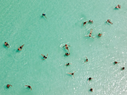sunfornia:   fairhy:   Dead Sea, Israel Photograph by George Steinmetz, National GeographicSwimmers float effortlessly in the salt-laden waters of the Dead Sea near Ein Bokek, Israel. Ten times saltier than seawater, the lake is extremely buoyant and