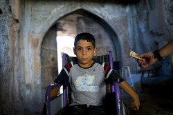 Syrian refugee kid in a wheelchair, Iraq