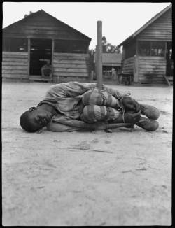 atane:  buuuuuuuuug: A young worker at a forced labor camp is tied to a pickaxe as punishment. Texas, early 1930s. PBS did a documentary a while back called “Slavery By Another Name” and this image was part of it. The level of depravity and violence