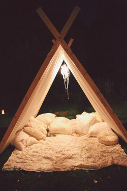 bukoladreamwedding:  “There were flower petals and candles and lights everywhere with a teepee with sparkling cider and pillows and blankets inside and a movie screen set up. Aaron pressed play to the movie he had worked on for hours, came and sat by