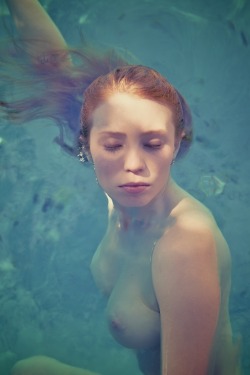 redrule:  Great breasts on this redhead floating in the pool.