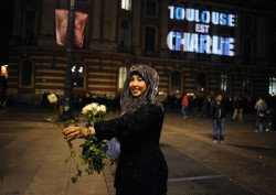  A muslim girl distributing flowers in France