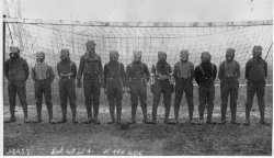 Soccer team of British soldiers with gas masks, World War I, somewhere in Northern France, 1916.