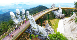 itscolossal:Vietnam’s Newly Opened Pedestrian Bridge Lifts Visitors with a Pair of Giant Weathered Hands