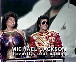 rebelliousrebe:   theenigmaticmoon:   thatmichaeljackson:  Michael Jackson accepts an AMA, as Angela Bowfill tries to keep her shit together behind him because he’d just kissed her on the cheek.   LMFAO!!! I am ROLLING OMG!   That would be  me too 