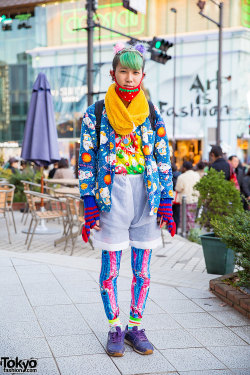 tokyo-fashion:  19-year-old Kanata on the street in Harajuku. His look features green partially-shaved hair with pompoms and a tiara, a resale Hello Kitty jacket over an M&amp;Ms top, sheer high-waist shorts, piercings, and Reebok sneakers. Full Look