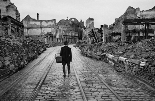A man walks through the destroyed city looking for food, 1945. © Werner Bischof