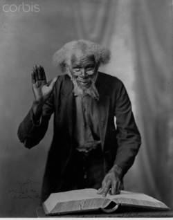 bookpatrol:  Elderly African American Man and BookAn old Black man with thick curly grey hair holding one palm up as if pledging. The original, racist title of this photograph, which can still be read slightly along the bottom of the print, is I don’t