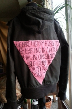 qcrip: sixthsomatic:  catnipcrazies: Finally finished the back patch I’ve been working on for weeks. THIS LOOKS SO GOOD  [back patch with an upside down pink triangle with embroidered text reading “We make history everyday by existing in a world that