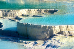 sixpenceee:    The Pamukkale Rock Pools in Turkey    The natural rock pools in Pamukkale, Turkey is an extraordinary natural wonder. The mineral-rich waters rise from the ground at a temperature of 35°C and tumble down the mountain from a height of 100