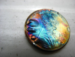 stunningpicture:  A firework fell over on the ground and did this to a penny. 