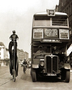 Karl Sander, a former German circus performer, demostrates his novel way of advertising as he rides besides a bus in Streatham in south London, 9 August 1932.