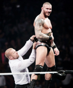 Randy bulging as Triple H straps the WWE Championship on him!