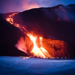 Too close for comfort (cars line up at the crest of a lava flow erupting from Eyjafjallajkull volcano in Iceland)