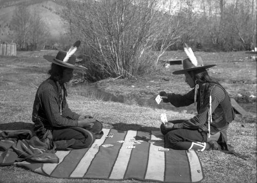 thebigkelu:  Antoine Moiese (“Grizzly Door”) and Michael, two Native American men on the Flathead Indian Reservation in western Montana, sit on a striped blanket playing cards. - Boos - 1905-1907