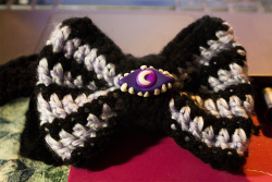 Crocheted bowtie for my Cecil cosplay! Button is scuplted from Primo and Fimo&rsquo;s glow in the dark. It&rsquo;s really strong! I picked up the yarn years ago when a ton of it went on clearance, good thing I held onto it! I&rsquo;m surprised how well
