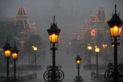 neverrlaand:  get-a-fucking-pen:  lanaismyevilqueen:   disneyland during rain, or fog, or darkness is my favorite, it truly looks like a hazy dream.  This has to be the most beautiful thing I’ve ever seen  looks more like halloween town than disney