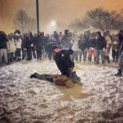 drag0n-spell:A police officer was struck by a snowball in Boston during a huge public snowball fight.So naturally he tased a kid and pushed his face in the snow for several minutes, which caused a crowd to circle the officer in protest.This is a raw image