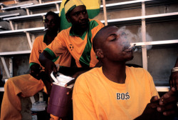 africansouljah:  Alex WebbJAMAICA. Kingston. 1998. Supporters smoke ganja in the stadium before a match against Sweden.