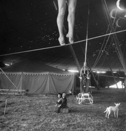 bygoneamericana:  Two small children watching a circus performer practicing on the tightrope. Sarasota, Florida, 1949. By Nina Leen 