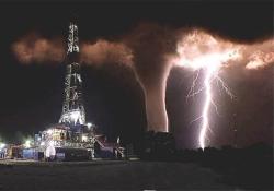 oneheartoverthemoon:  ba614:  THIS IS A PICTURE THAT SOMEONE TOOK WHO WORKS ON AN OIL RIG IN TEXAS.HE WANTED TO GET A SHOT OF THE LIGHTNING THAT WAS FLASHING BY. HE WAS UNAWARE OF THE TORNADO UNTIL THE LIGHTNING ILLUMINATED IT.This has been called a