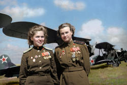 fcba:  Soviet “Night Witches” Rufina Gasheva and Nataly Meklin pose in front of their Po-2 biplanes during the Second World War. Both were decorated as Heroes of the Soviet Union for their actions while a part of the famed unit. (WWII in Color)  